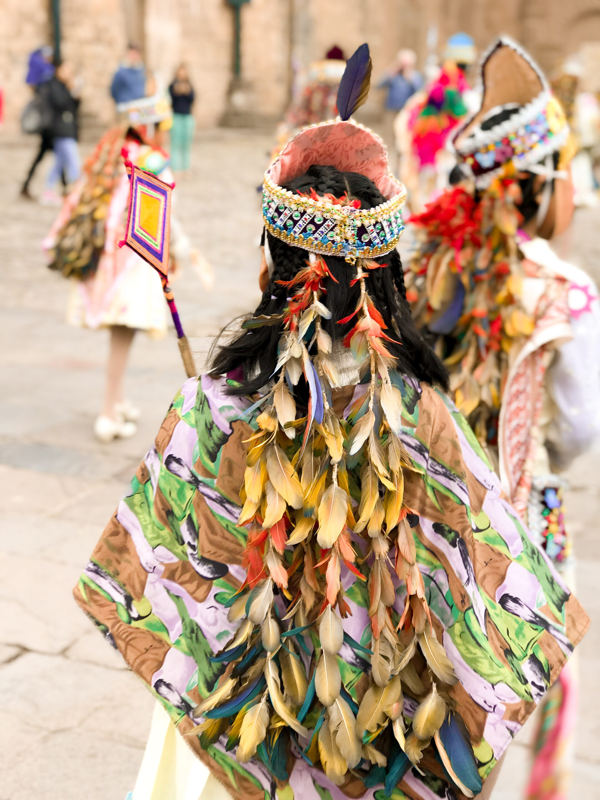 bambina con abiti tipici di piume colorate